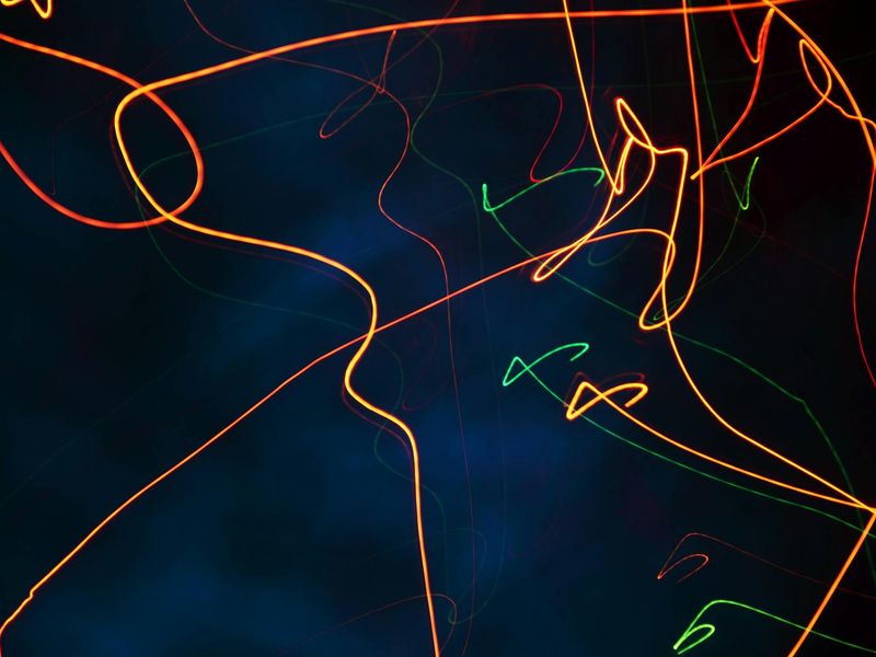 Abstract orange light trails symbolizing the flow of movement.