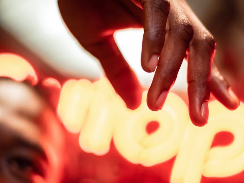 Person in a dynamic yoga pose against a dark background.